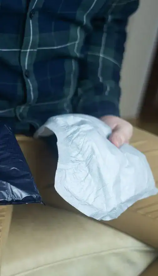 Image of man holding incontinence pads as part of overactive bladder treatment Doncaster