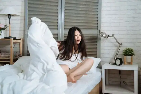 Image of woman getting up because of nighttime leaks Doncaster